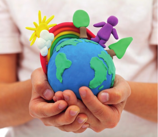 Childs hands hold play-clay model of the earth with play-clay rainbow, sun trees and stick person stuck on top