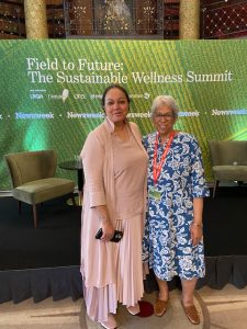 Pat Dale and Salma Abbasi standing in front of the Feild to Future banner